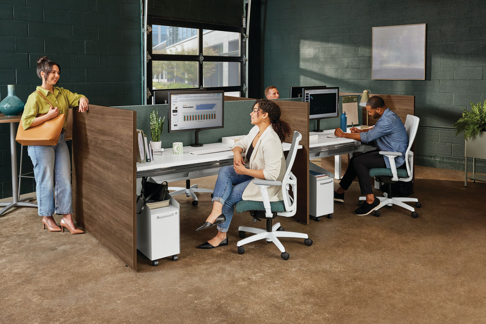 Workers collaborating at their workstations